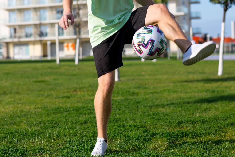 Man kicking soccer ball