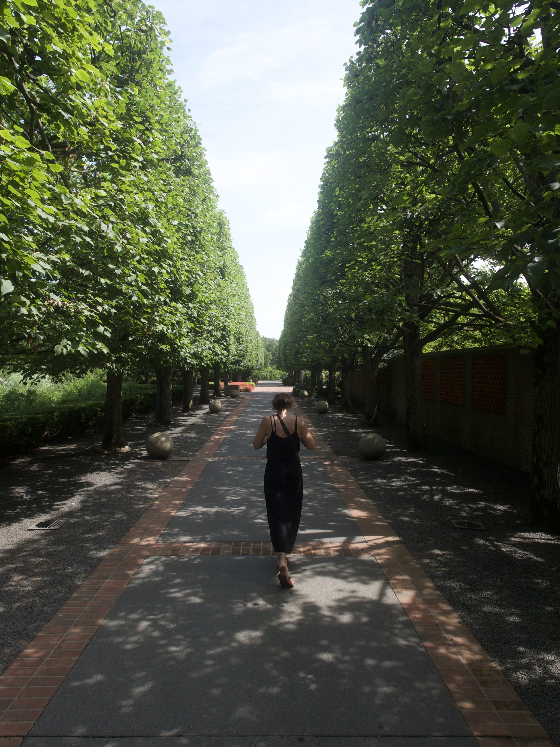 Woman Walking Down Garden Path